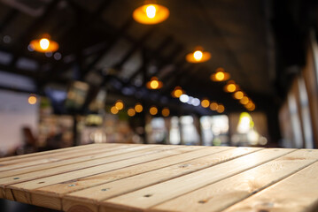 wood table on blur of cafe, coffee shop, bar, background - can used for display or montage your...