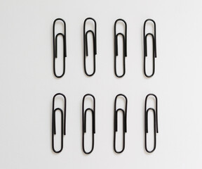 black paperclips on a white background