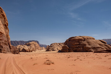 Fototapeta na wymiar Dirt Road Cutting Through the Wadi Rum Desert in Jordan