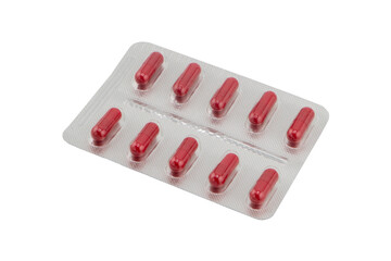 Macro shot pile of red tablets pill in silver blister packaging isolated on white background....