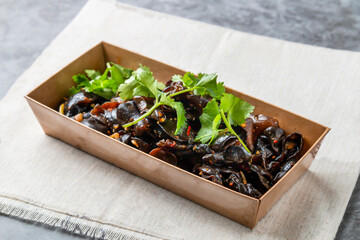 Cold cloud fungus with coriander served in dish isolated on wooden table side view of hong kong fast food