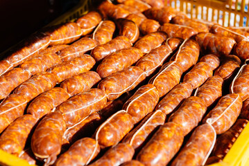 Close up of cointainer full of raw homemade chorizo sausages
