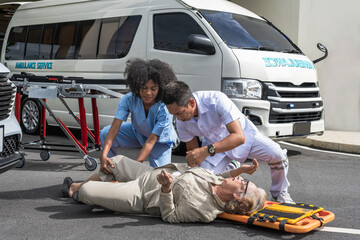 Black rescue woman and Asian ambulance man teammate helping unconscious old lady patient  rushing...