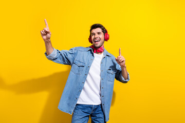 Photo portrait of handsome young guy listen music dancing earphones wear trendy jeans outfit...