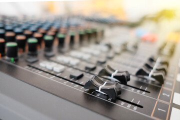 Mixing console in sound recording studio with shallow depth of field.