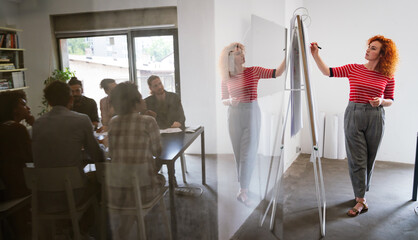 Diverse employees gathered in the office having fun during brainstorming while discussing new ideas