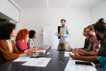 Happy coworker startup people working and having meeting with friendly diverse colleagues in office.