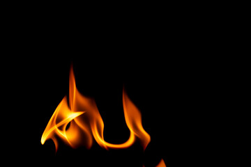 Naklejka premium Hot flames on a black background. Beautiful flame of fire in the dark. Abstract of burning flames and smoke.