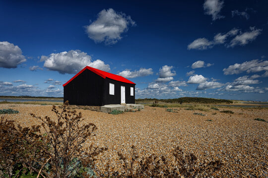 Red Roofed Hut on the Shingle at the Nature reserve in Rye Harbour Sussex England UK