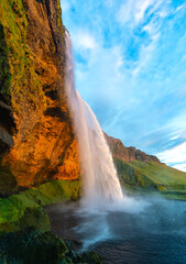 Seljalandsfoss is an impressive cascade on the south coast of Iceland. Majestic waterfall in warm...