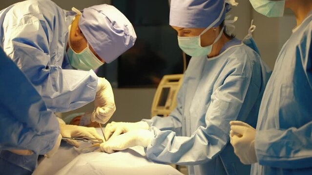 Surgeon doing surgery inside operating room to help emergency patients, medical care concept, health, life insurance
