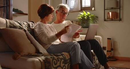 At home, a middle-aged couple monitors bills and taxes to pay and must be careful about their household finances.
The two pensioners are sad and worried - Powered by Adobe