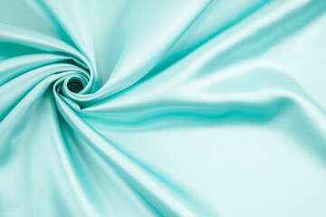 Abstract background texture. Light green silk or liquid with soft waves.