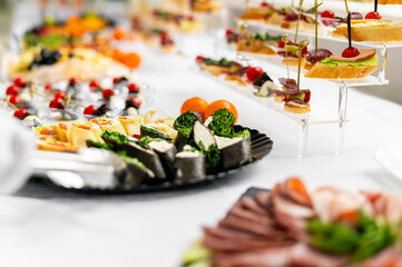 woman hands of a waiter prepare food for a buffet table in a restaurant