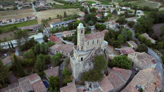 The chapel Notre-Dame de la Consolation, built in 1894 atop a rocky spur overlooking a village in Pierrelongue. The chapel is designed like Notre-Dame de Lourdes basilica. 