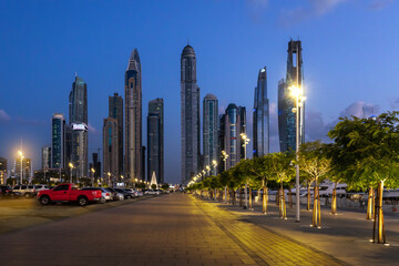Beautiful view of pedestrian walkway in district Dubai Marina in evening night illuminations at...