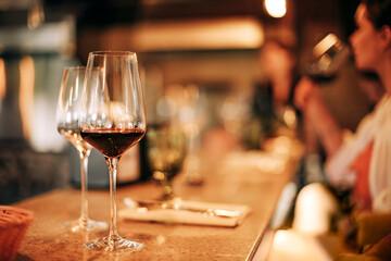 Wine bottle and glasses on the table, against the background of wine dinner.