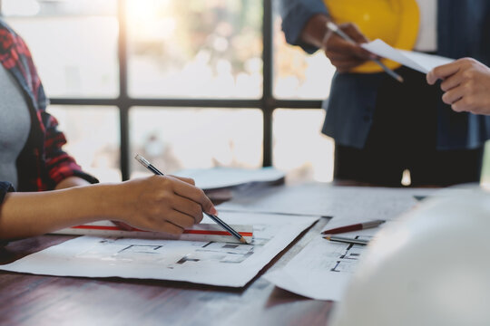 Architect or engineer are meeting to discuss house designs, modify plans for construction projects, and additions according to customer needs.
