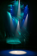 Vertical background of multi-colored lighting from stage spotlights.