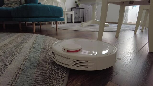 Vacuum Robot cleaning at home. Robot vacuum cleaner in the modern home. Smart cleaning technology