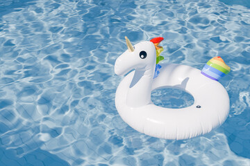 3D rendering of an inflatable unicorn float in a swimming pool with clear water, summer concept. © Antonio Solano