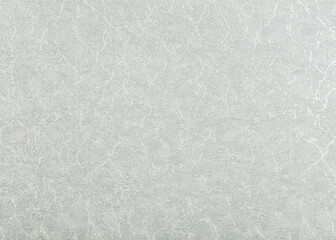 Background of gray paper wallpaper with evenly foamed white spots.