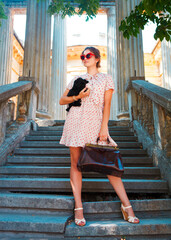 Young brunette woman hugging her lap dog puppy