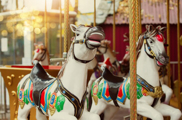 Fototapeta na wymiar Vintage retro carousel horse. Children's attraction in the old park.Childhood memories.