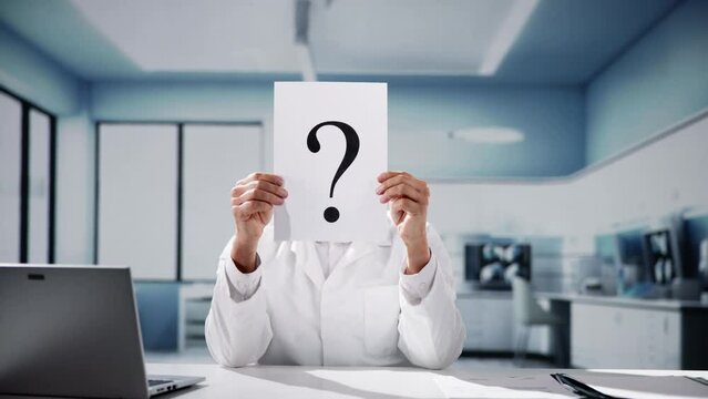 Male Doctor Holding Question Mark