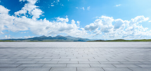 Wide square floor and green mountain nature landscape under blue sky. Panoramic view.