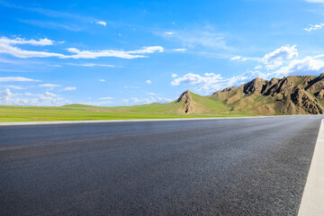 Country road and green grass with mountain nature landscape under the blue sky - Powered by Adobe