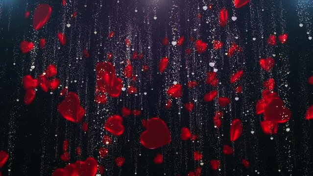 Hundreds of bright red hearts slowly fall surrounded by golden particles.