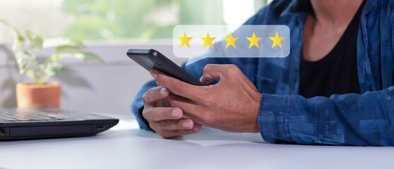 Customer pressing on smartphone with five stars icon for feedback review satisfaction service	
