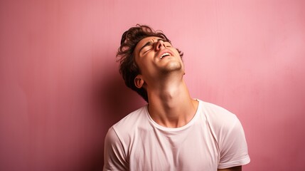 Obraz premium young man standing over pink background stretching back, tired and relaxed, sleepy and yawning for early morning