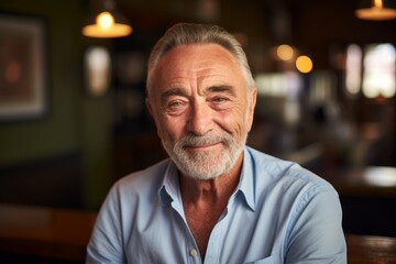 Portrait of a senior man sitting in a pub and smiling