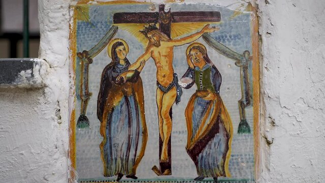 Italian hand painted ceramic tile depicting the crucifixion Christ on a wall in the town Vietri sul-Mare on the Amalfi Coast.