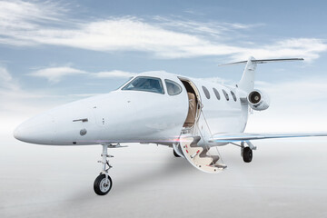 White business jet with an opened gangway door isolated on bright background with sky - obrazy, fototapety, plakaty