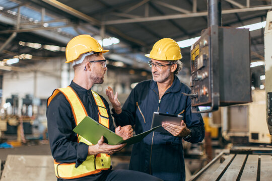 Senior Supervisor Male Talking With Young New Engineer Employee Training Teaching For Machine Operate