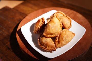 Curry puff snacks Traditional Thai desserts On the wooden table