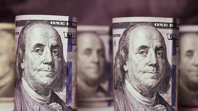 100 dollar bills are first illuminated, then plunged into darkness. Concept of finance, money, business, dollar crisis.