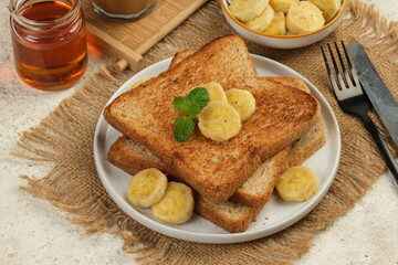 french toast with banana and honey on white background