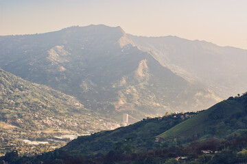 relax tropical forest with mountains and a city in the background
