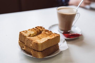 Traditional Portuguese breakfast - toasted bread with butter and coffee, Portugal