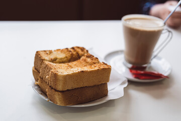 Traditional Portuguese breakfast - toasted bread with butter and coffee, Portugal