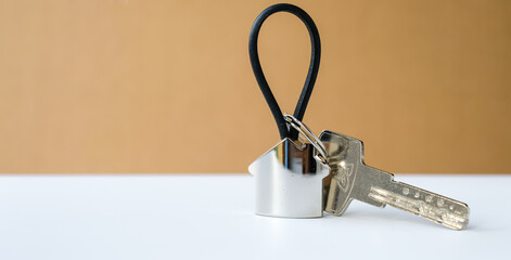 Keyring looks like the house. The key.  Apartment concept.