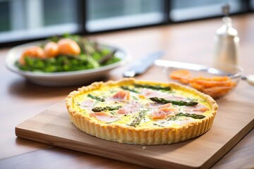 quiche with roasted asparagus on a wooden board