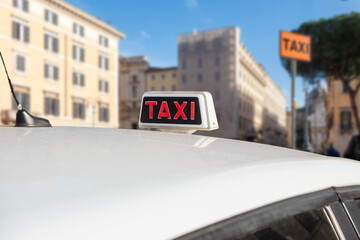 Taxi station. Taxi sign. White taxis waiting