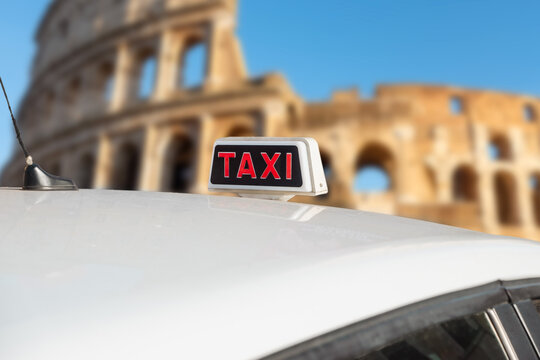 Taxi in Rome, Italy. Italian white taxi with sing on the roof in front the Colosseum.