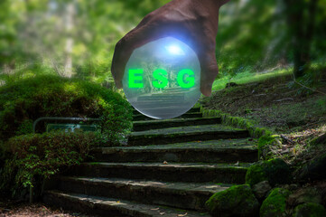 hand holding crystal ball ESG concept. Environment society and governance sustainable business on...
