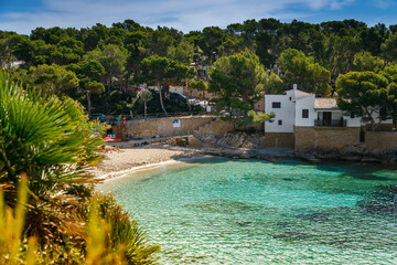 Sandy shore, pristine waters and the natural coastal setting in Cala Gat beach